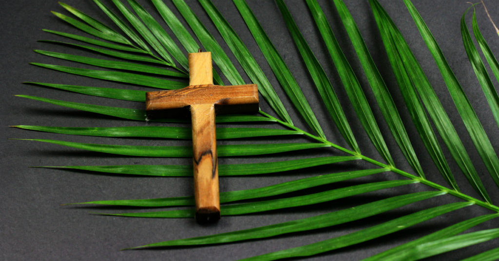 9166-palm-sunday-easter-wooden-cross-on-palm-getty